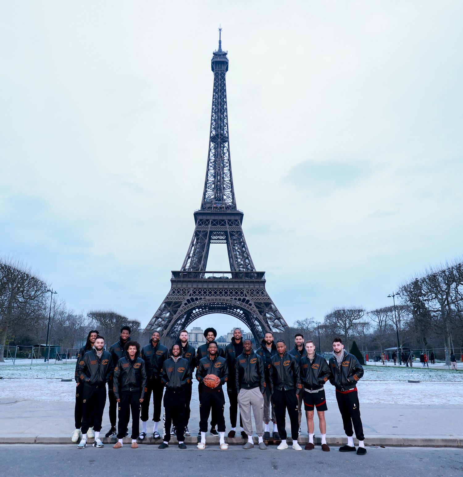 The Cleveland Cavaliers pose for a team photo in front of the Eiffel Tower in Paris, France.